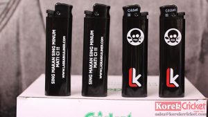 Korek api gas merek cricket warna body hitam sablon logo laskar kuliner Bali